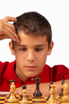Teenager in full concentration while playing chess
