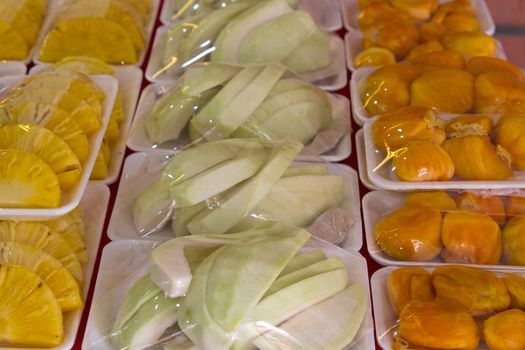 Fresh Fruits Cut and Shrink Wrapped on Vendor Stand