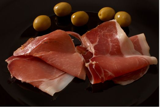 Spanish serrano ham served with olives