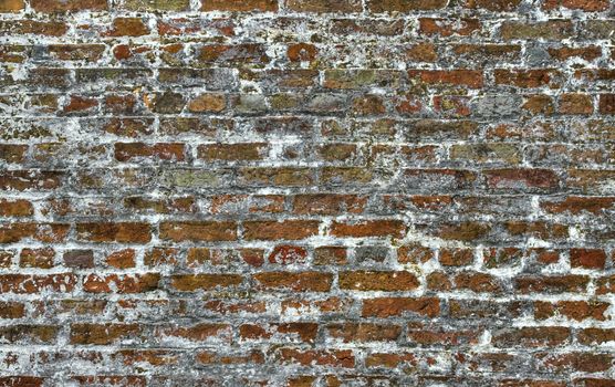 A brick wall that is old and decaying