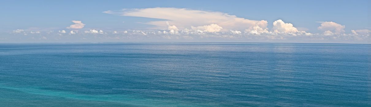 Panoramic seascape with blue water and sky.