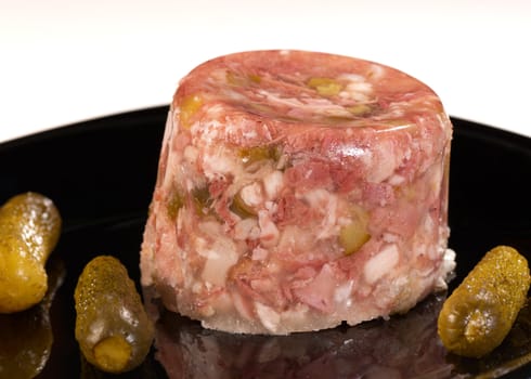 Jellied pork meat served with sour pickles, cold starter
