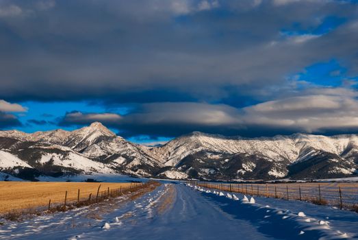 Winter Road, Ross Peak and clouds in late afternoon, Gallatin County, Montana, USA