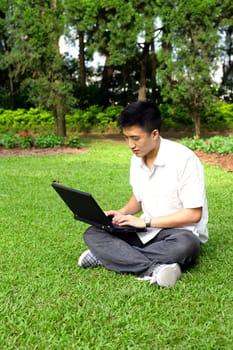 asian man using computer outdoor