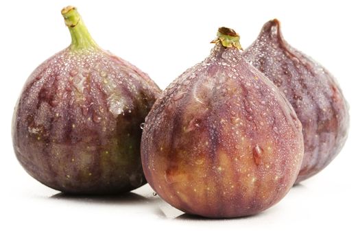 three wet figs on white background