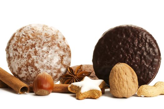 traditional german lebkuchen setup with hazelnuts cinnamon sticks and star anise on white background