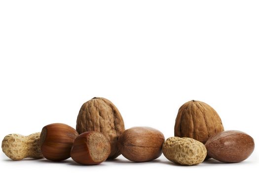 two of each pecan hazelnuts walnuts and peanuts on white background