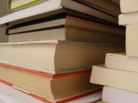 a pile of books on a desk