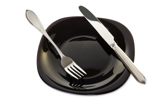 Black high-gloss plate with stainless fork and knife