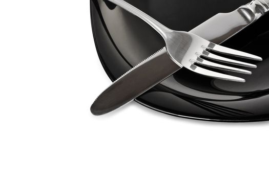 Black high-gloss plate with stainless fork and knife