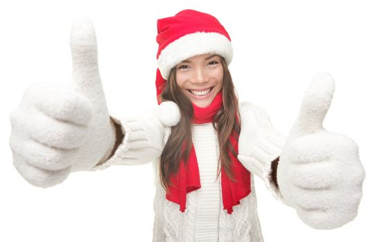 Christmas woman thumbs up success hand sign. Young smiling woman in Santa hat and warm winter sweater. Isolated on white background.Funny photo of Asian Chinese / white Caucasian female model.
