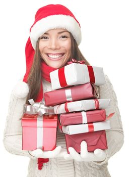 Christmas woman holding gifts wearing Santa hat. Smiling woman portrait of a beautiful mixed Asian / Caucasian model. Isolated on white background. 