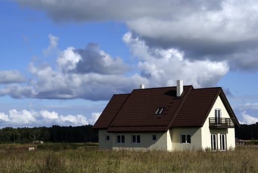 The modern house on a background of clouds