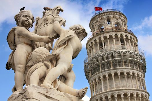 Leaning tower and statue angel in Pisa, Tuscany, Italy 