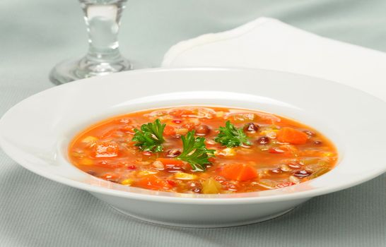 Bowl of delicious soup full of fresh vegetables.