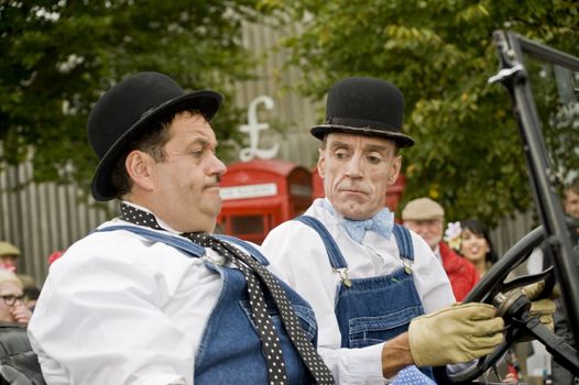 Two actors in a role of drivers old car, taken on September 2011 on Goodwood revial in UK