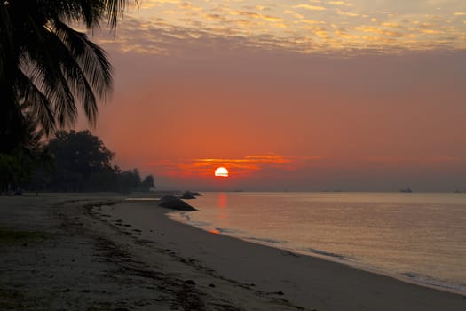 Sunrise over the horizon at East Coast Park Beach in Singapore