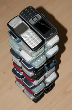 Many old mobile phone in a sort of stack