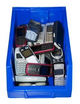Lots of old mobile phones in a blue box