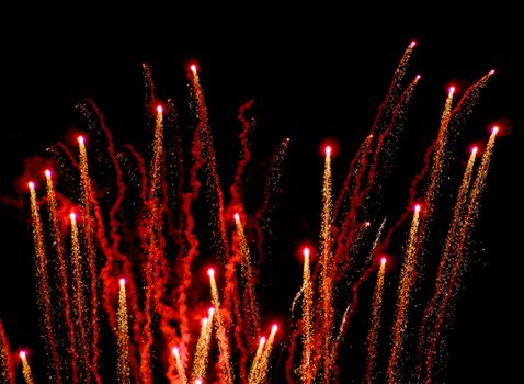 Red and Gold fireworks against the night sky.