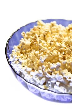 Popcorn in a blue basket. Isolated on a white background.