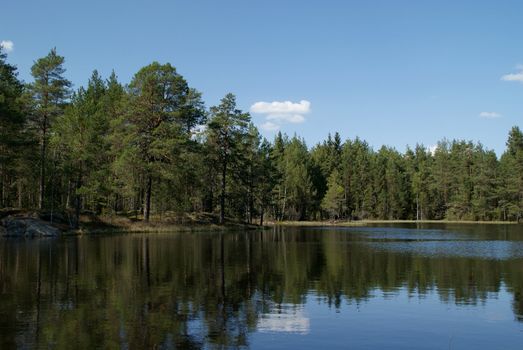 A quiet rural lake on a sunny day of spring. Photographed in Salo, Finland in May 2010.