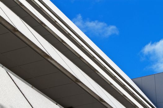 Multi-level angular building against blue sky and clouds