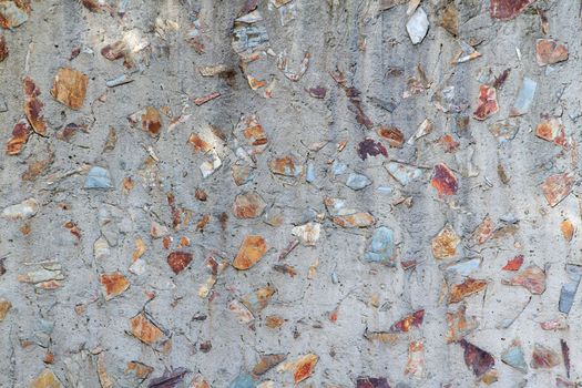 Concrete and mix of red and gray flat rocks and stones