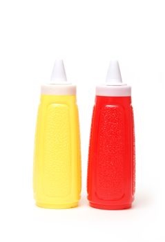 Two condiment containers of mustard and ketchup.