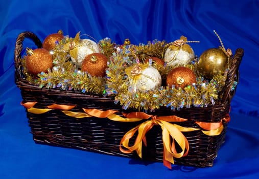 Basket with Christmas balls on the dark blue background