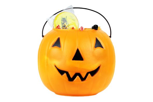 Jack O' Lantern with candy isolated on white. Clipping path included.