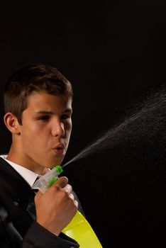 Teenager impersonating James Bond, shooting his cleaning gun