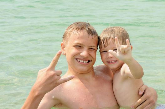 Happy brothers play the sea