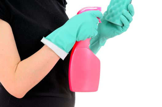 The woman in green gloves pours a washing-up liquid on a sponge