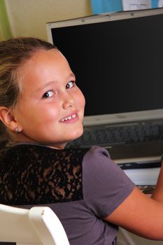 girl is sitting on her desk with a notebook