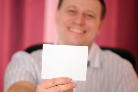 The man holds in a hand card blank