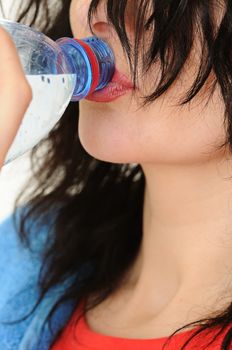 The beautiful woman drink a water is shoot close up