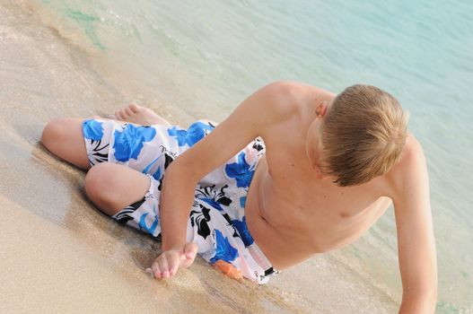 The young man bathes in the sea