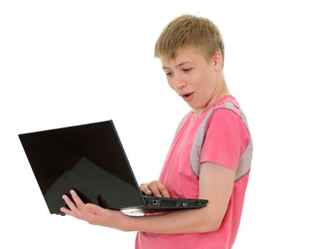 The surprised teenager with laptop isolated on white background