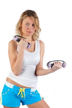 A woman carries athletic exercise with dumbbells
