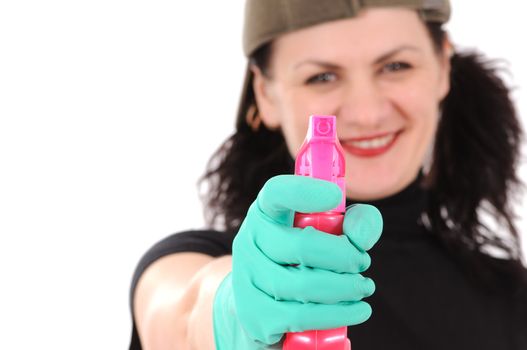 The woman in a cap and green gloves washes a window