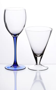 Two transparent empty glasses stand on a table