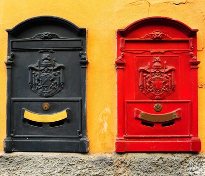 Black And Red Post Boxes On The Yellow Wall