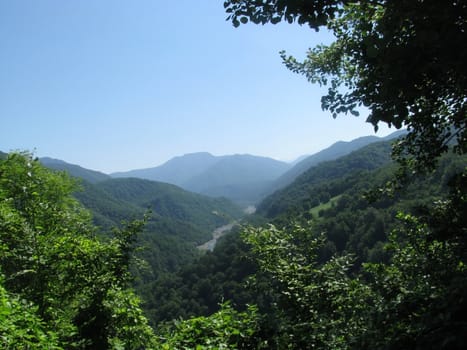 Mountains, rocks; a relief; a landscape; a hill; a panorama; Caucasus; top; a slope; clouds; the sky; a landscape