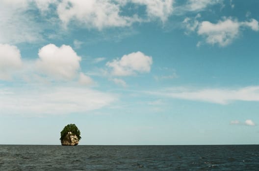 A small island out of sea, with clear sky background