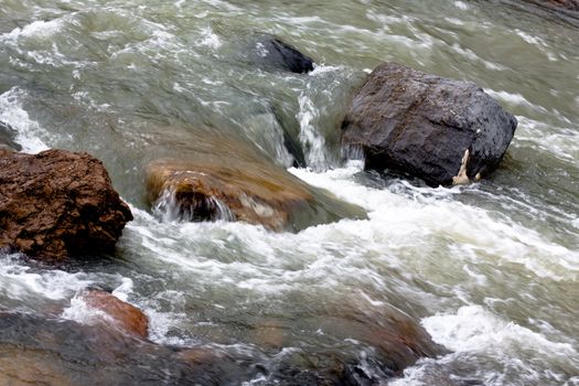 A white stream between stones
