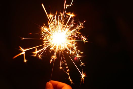 hand holding a burning sparkler