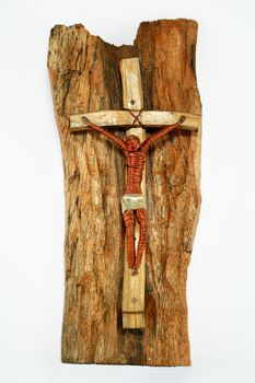 copperwire and wooden crucifix on wood and white background
