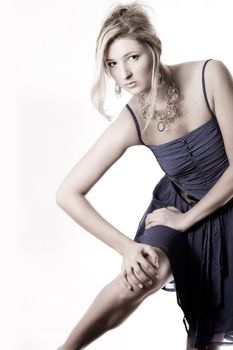 Young girl in a dress in the studio on a white background