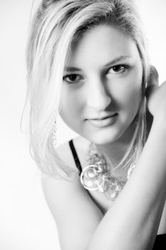 Young girl in a dress in the studio on a white background